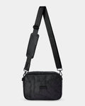 Black quilted crossbody bag with a strap on a light gray background