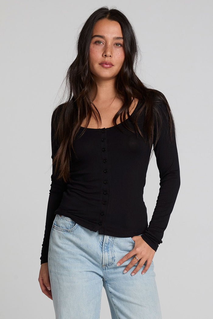 A full body front view of a woman wearing the Chaser Silva Black Fullsleeve Top on a neutral background