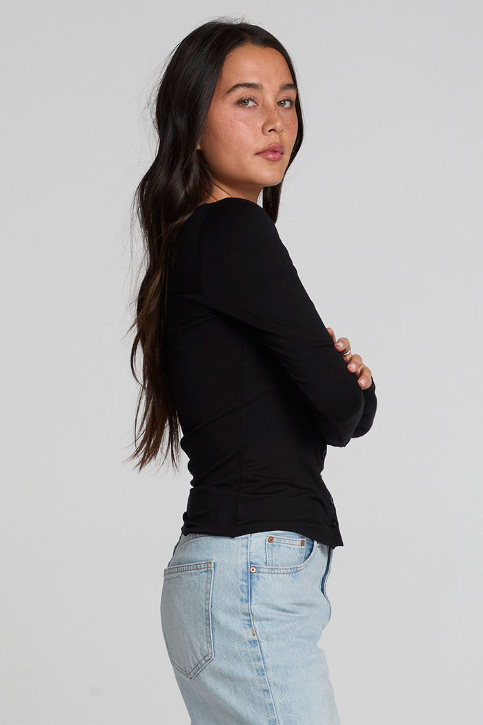 Side body view of a woman wearing the Chaser Silva Black Fullsleeve Top on a neutral background