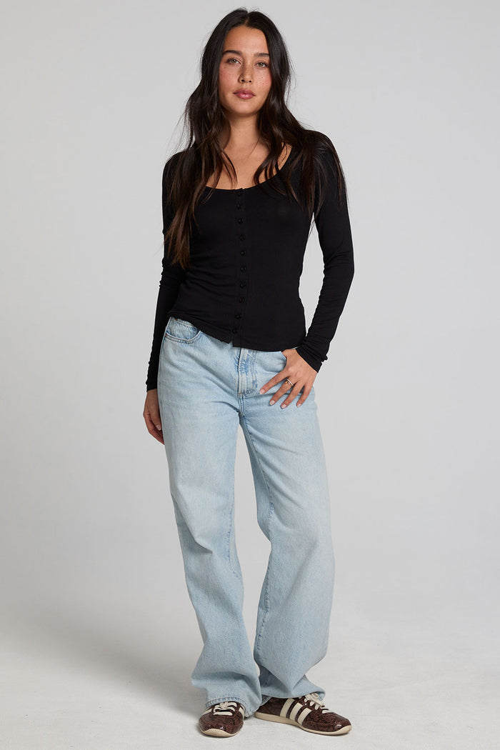 Full body front view of a woman wearing the Chaser Silva Black Fullsleeve Top on a neutral background
