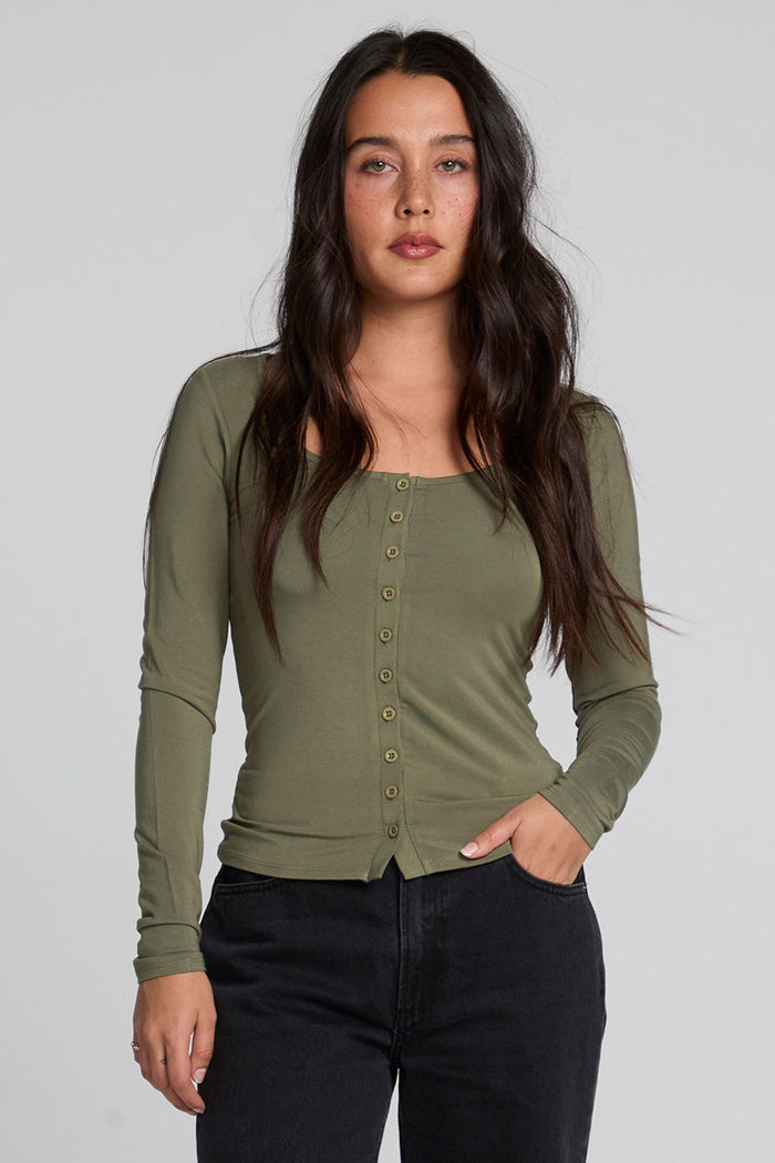 Front view of a woman wearing the Chaser Silva Forager Green Fullsleeve Top on a neutral background