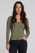 Front view of a woman wearing the Chaser Silva Forager Green Fullsleeve Top on a neutral background
