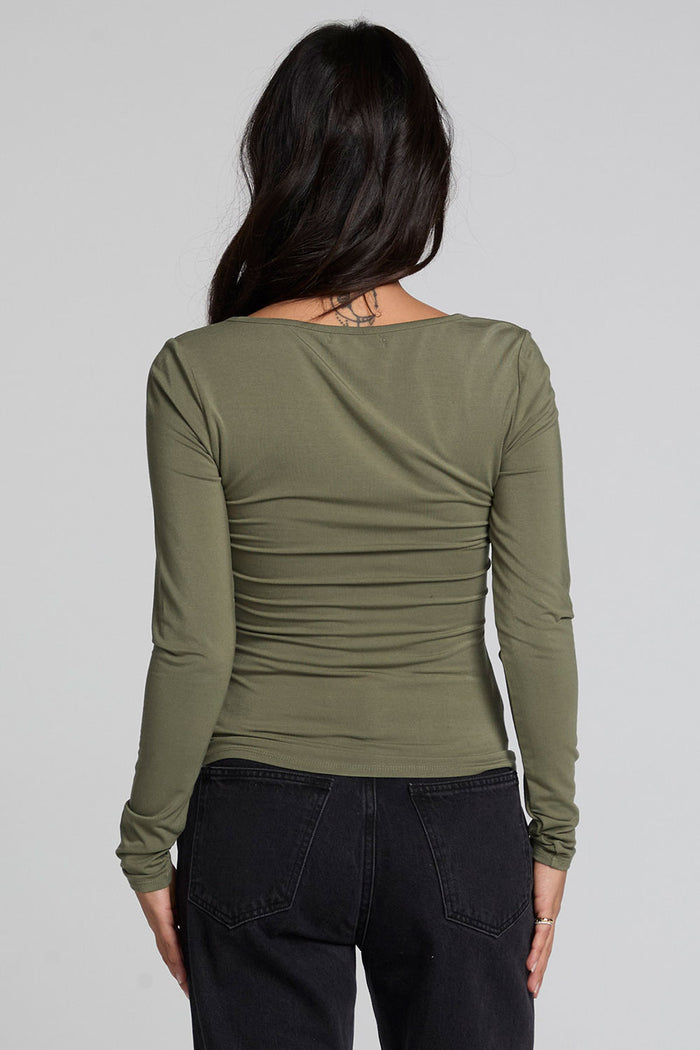 Back view of a woman wearing the Chaser Silva Forager Green Fullsleeve Top on a neutral background