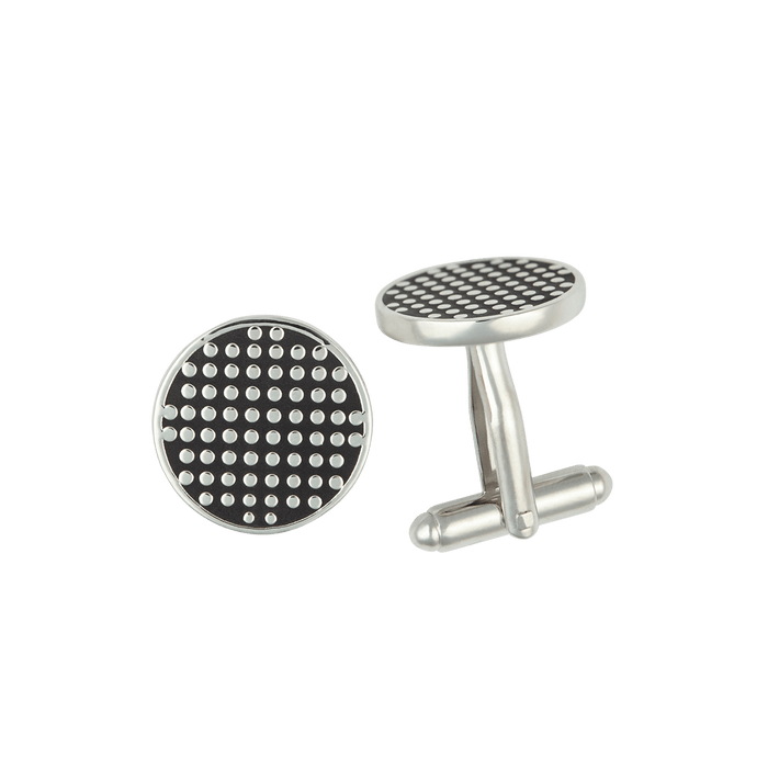 Silver cufflinks with black dot-pattern face, pair on light grey background