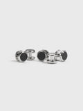 Set of silver button studs with black onyx centers on white background