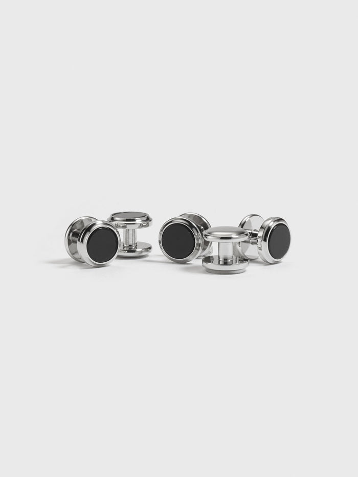 Set of silver button studs with black onyx centers on white background