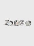 Set of silver shirt studs with mother-of-pearl faces on light grey background