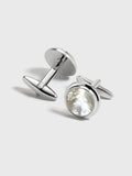 Silver cufflinks with round mother-of-pearl face, pair on light grey background