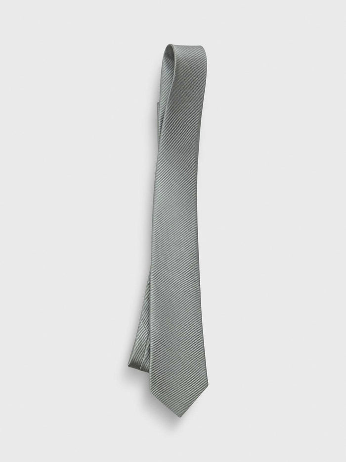 Silver sage silk tie draped in a loose loop on light grey background