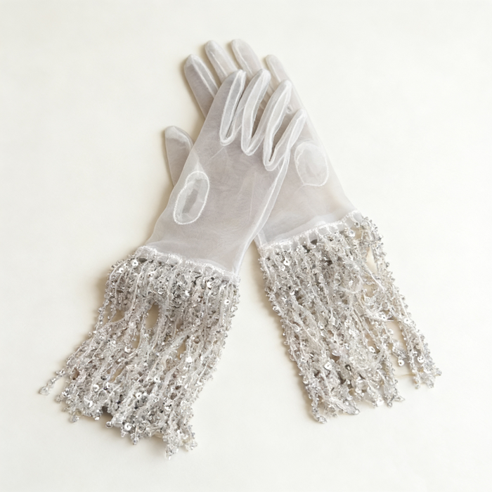 Silver sequin fringe bridal gloves with sheer fabric and sparkling tassel cuffs for wedding ceremony and evening styling.
