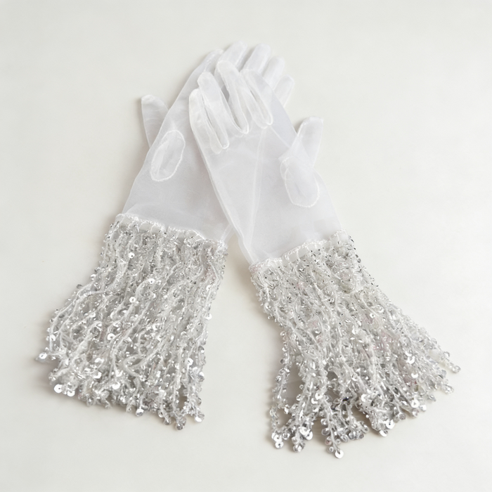 Silver sequin fringe bridal gloves with sheer fabric and sparkling tassel cuffs for wedding ceremony and evening styling.