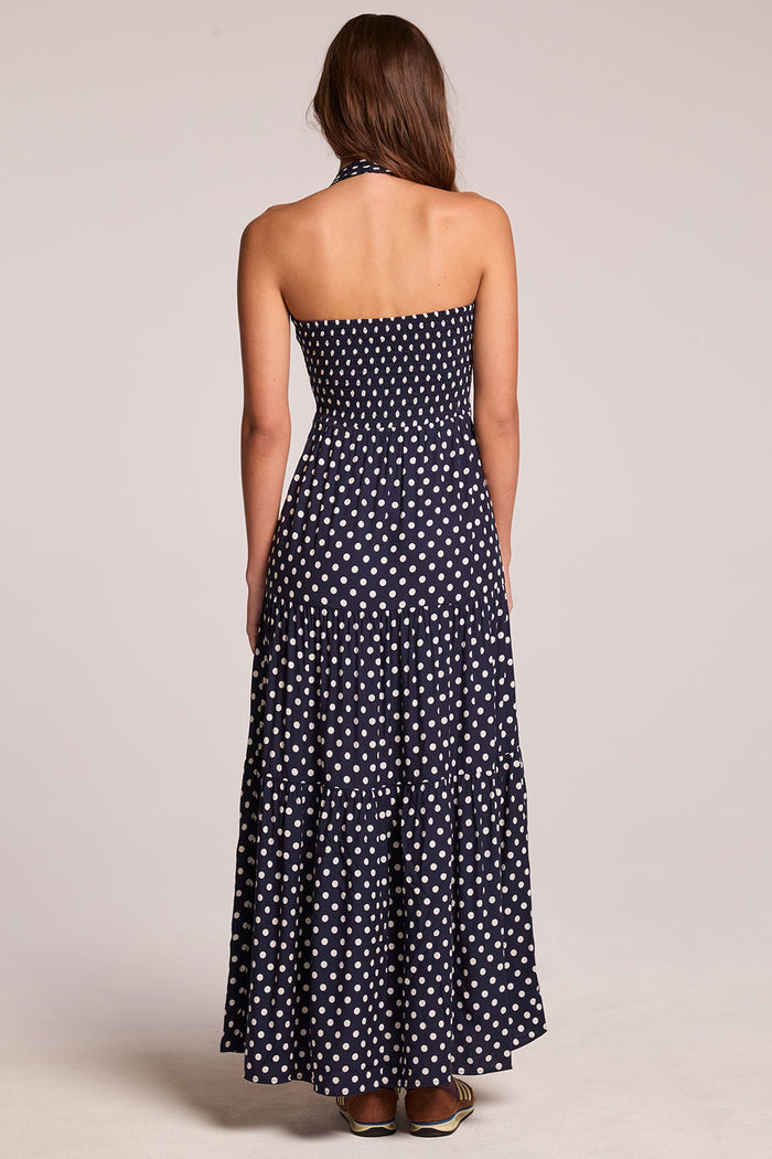 Back view of a woman wearing the Chaser  Siren Navy Spot Maxi Dress on a neutral background