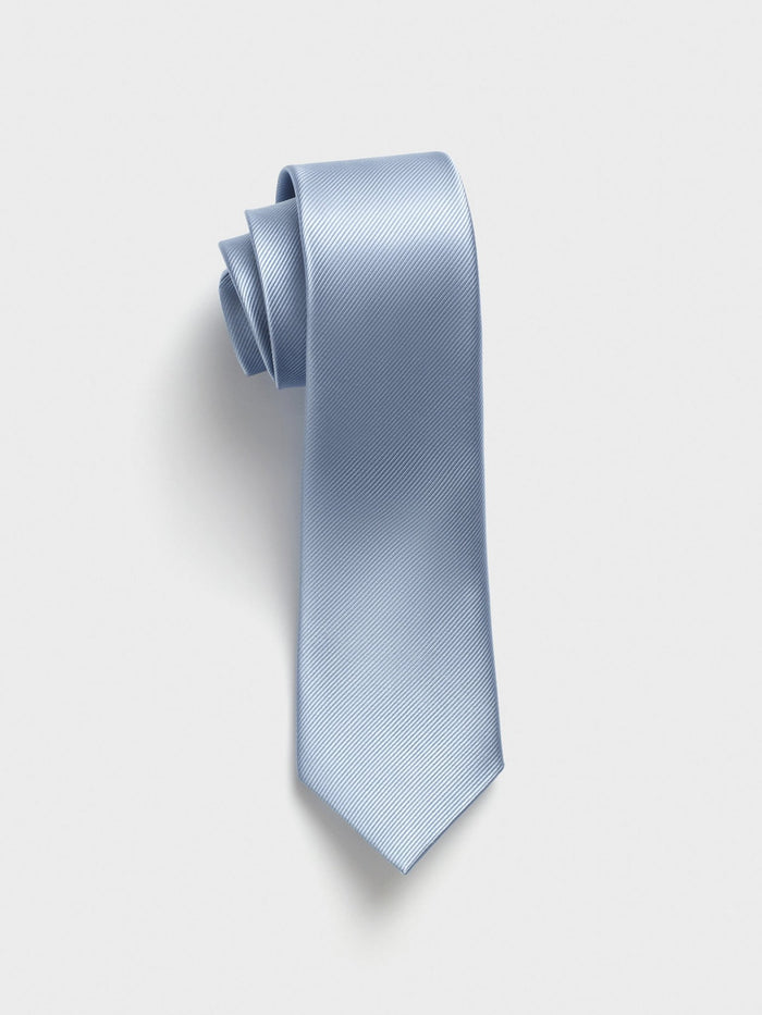 Sky blue silk tie, rolled, on light grey background
