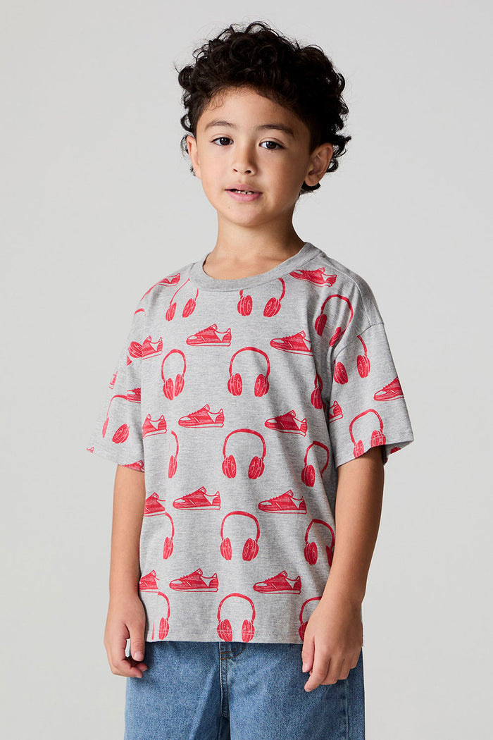 Front view of a boy wearing the Chaser Sneaks and Headphones Tee on a neutral background