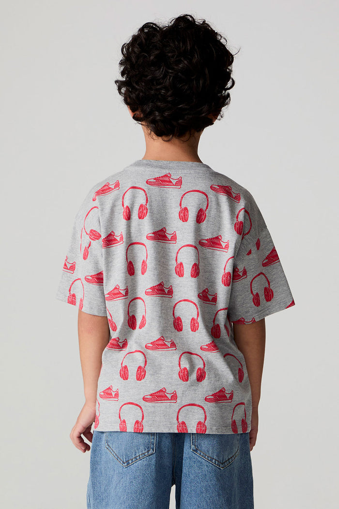 Back view of a boy wearing the Chaser Sneaks and Headphones Tee on a neutral background