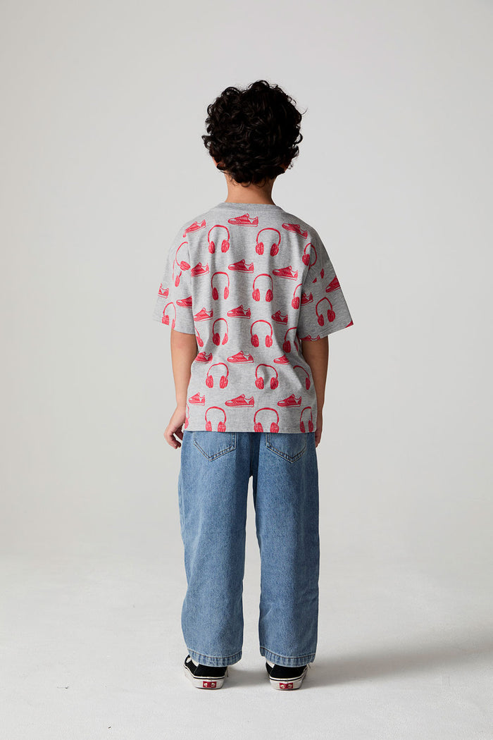 Full body back view of a boy wearing the Chaser Sneaks and Headphones Tee on a neutral background