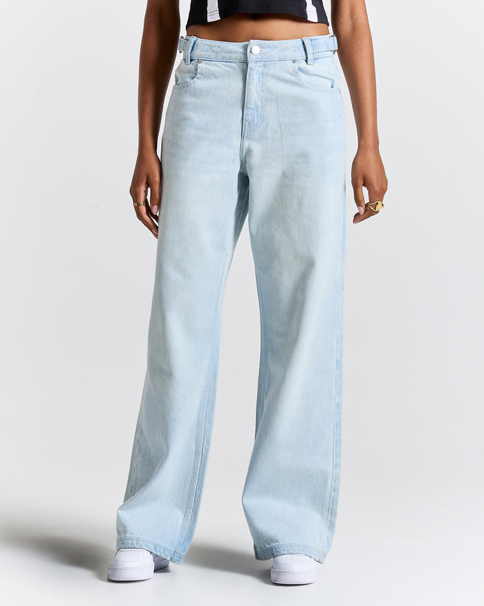 Light blue jeans worn by a person on a white background