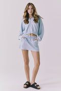 Chaser Soleil Blue Bird Mini Skort in Blue Bird styled with the matching Abilene Zip Up Hoodie in a coordinated lounge set with an easy sporty silhouette