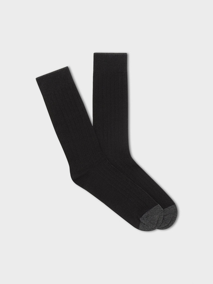 Pair of black ribbed dress socks with charcoal toe, folded flat on light grey background