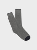 Pair of grey ribbed dress socks with navy toe and trim, folded flat on light grey background