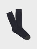 Pair of navy ribbed dress socks with charcoal toe, folded flat on light grey background
