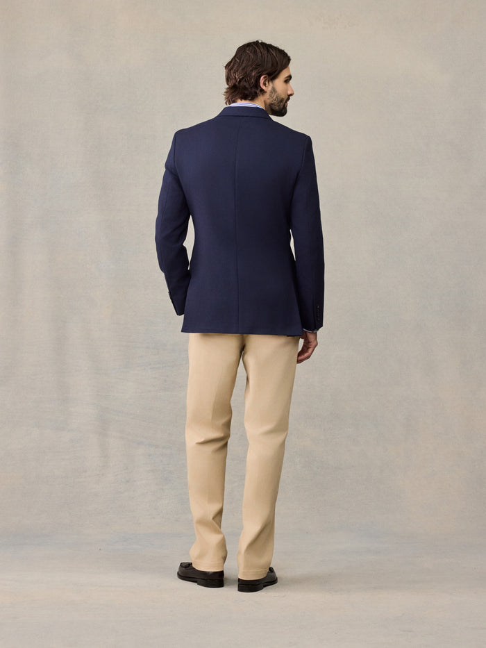 Back view of man in navy sportcoat and tan trousers