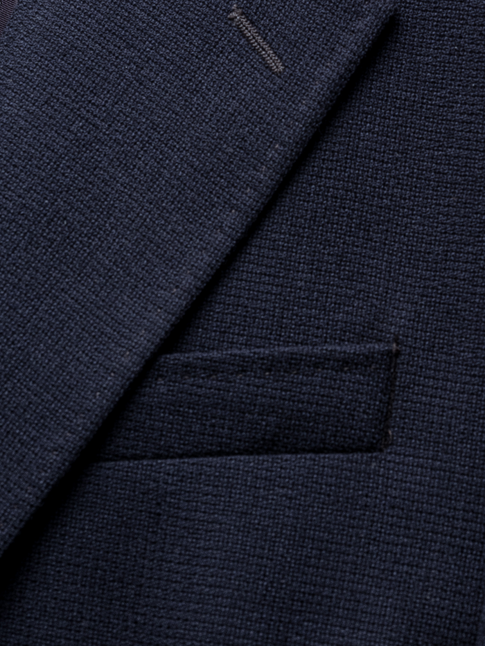 Close-up of navy sportcoat lapel and chest pocket texture