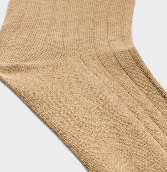 Close-up of tan ribbed dress sock knit texture and heel