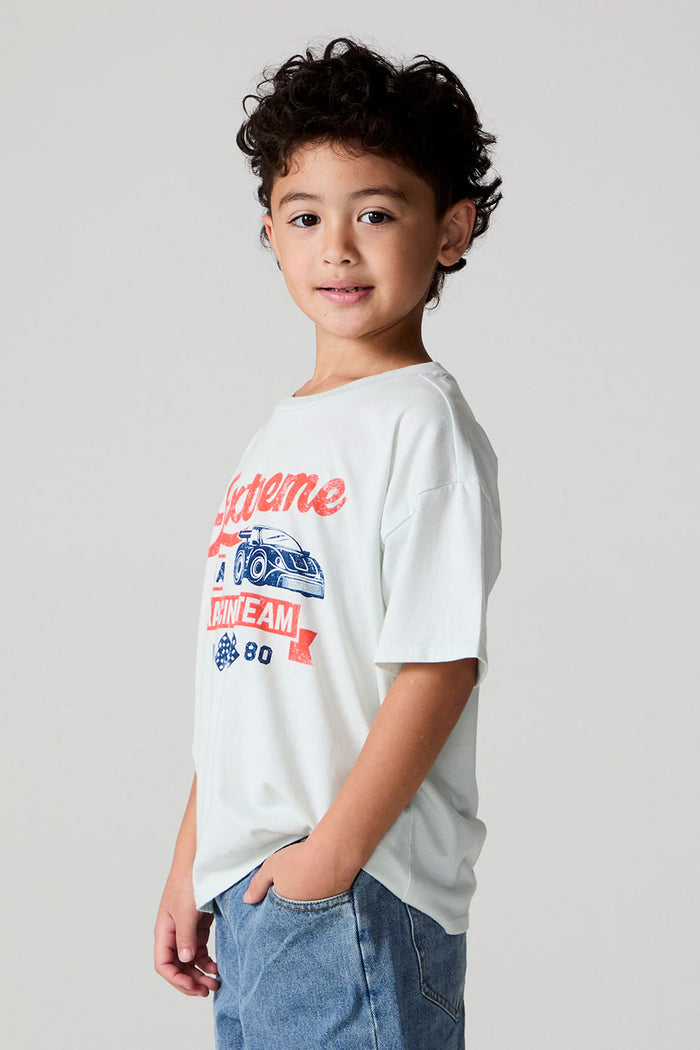Side angle view of a boy wearing the Chaser Speedway Tee on a neutral background