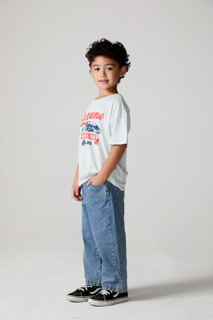 Full body side angle view of a boy wearing the Chaser Speedway Tee on a neutral background