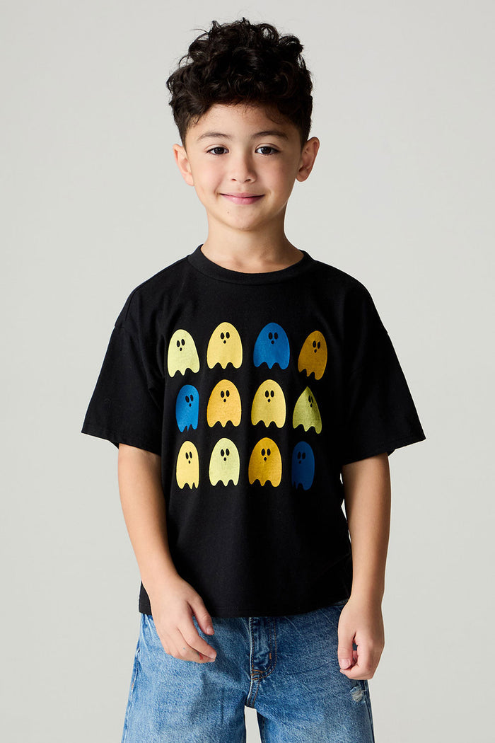 Front view of a boy wearing the Chaser Spooky Friends Boys Tee on a neutral background with baggy bluejeans