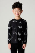 Front view of a boy wearing the Chaser Sports All Over Boys Tee on a neutral background with matching pants