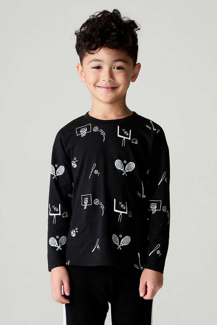Front view of a boy wearing the Chaser Sports All Over Boys Tee on a neutral background with matching pants