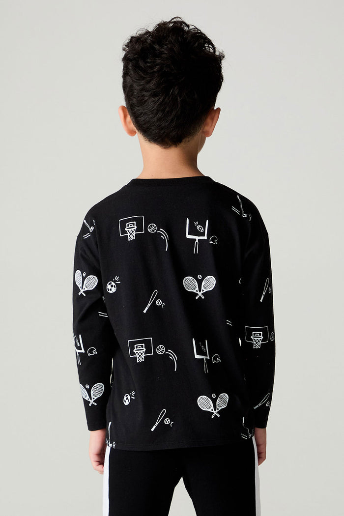 Back view of a boy wearing the Chaser Sports All Over Boys Tee on a neutral background with hands at sides