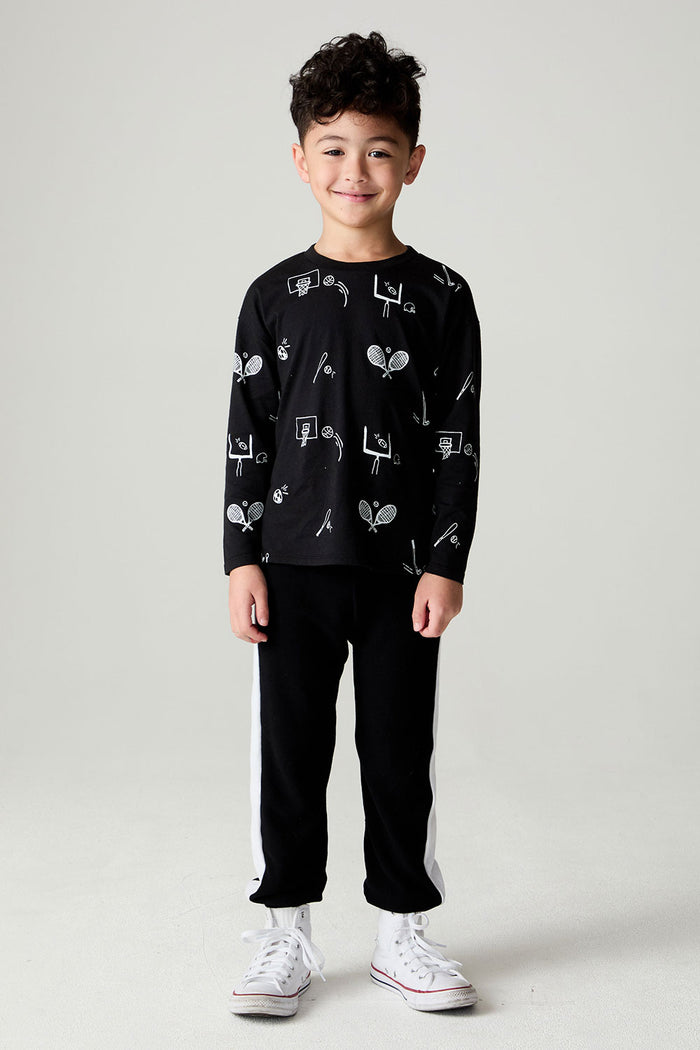 A full body front view of a boy wearing the Chaser Sports All Over Boys Tee on a neutral background