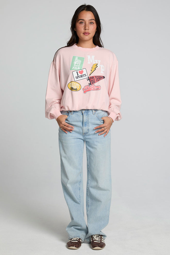 A full body front view of a woman wearing the Chaser Sporty Patches Long Sleeve Top on a neutral background