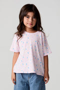 Front view of a girl wearing the Chaser Sprinkle Party Tee on a neutral background