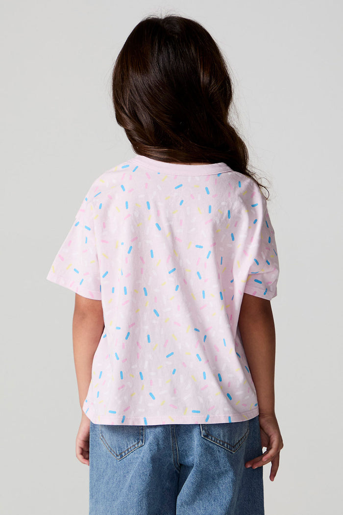 Back view of a girl wearing the Chaser Sprinkle Party Tee on a neutral background