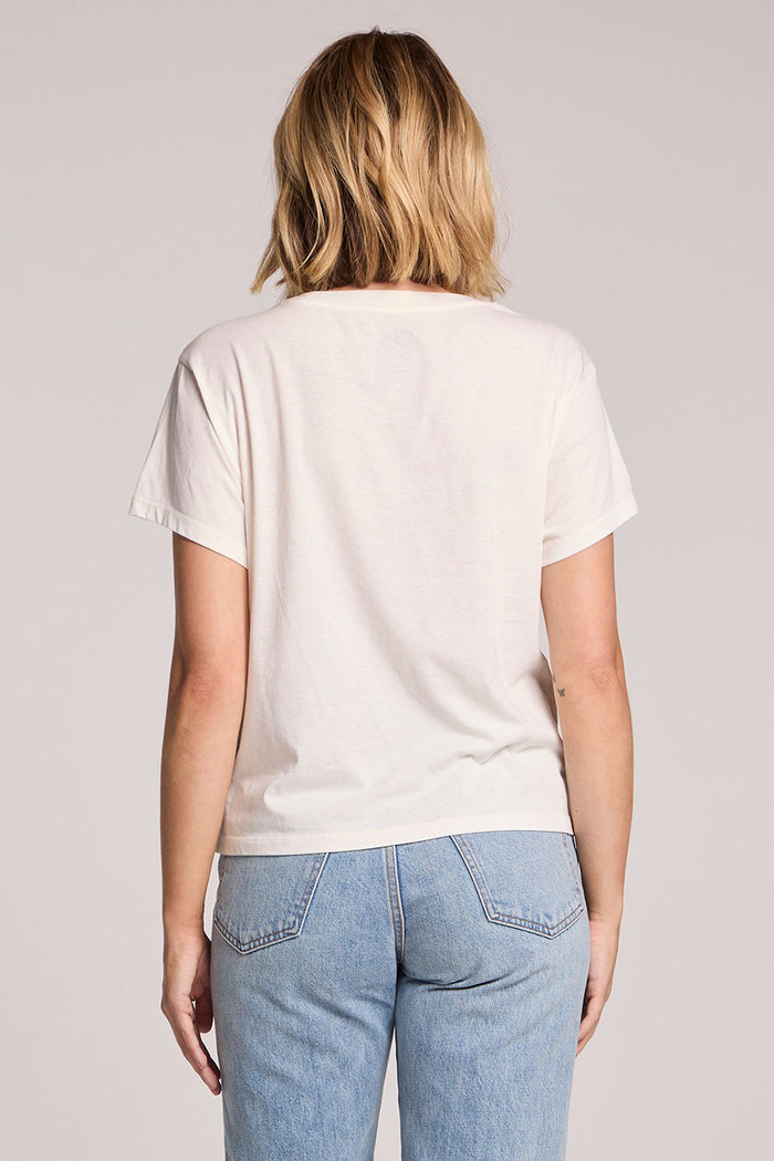 Back view of a woman wearing the Chaser Spritzing The Day Away Tee on a neutral background