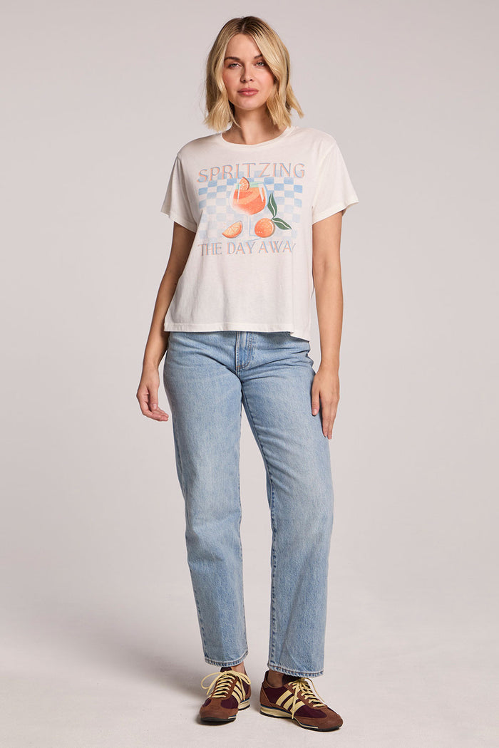 Full body front view of a woman wearing the Chaser Spritzing The Day Away Tee and sneakers on a neutral background