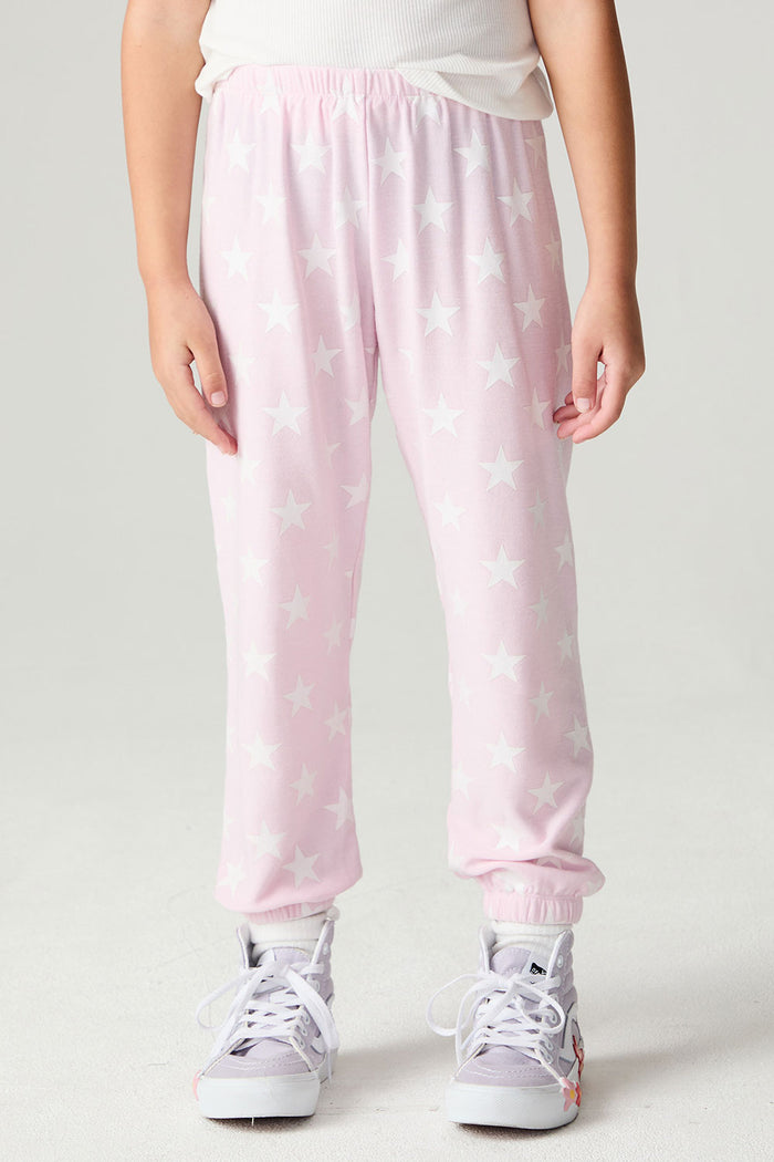 Front view of a girl wearing the Chaser Stars Allover Girls Jogger on a neutral background with arms lowered