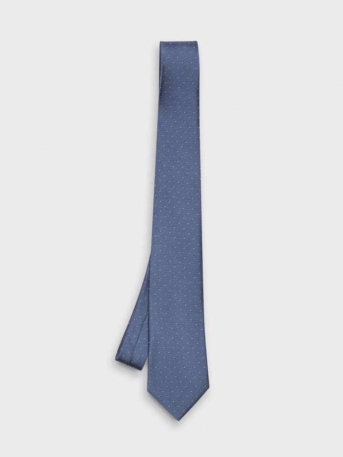Steel blue silk tie with white pindot pattern, hanging on light grey background