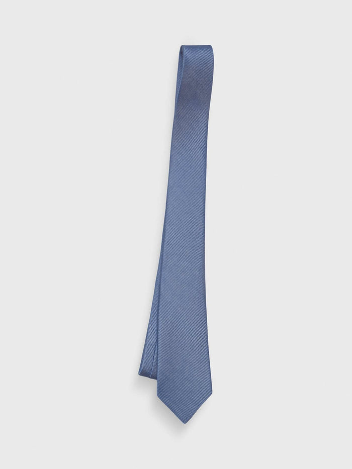 Steel blue silk tie with twill texture, hanging on light grey background