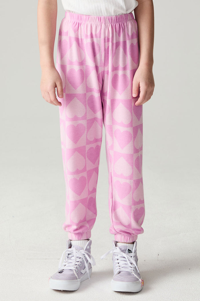 Front view of a girl wearing the Chaser Straight To The Heart Girls Jogger and white shirt on a neutral background