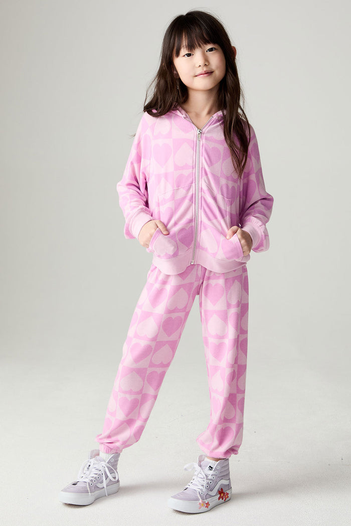 A full body front view of a girl wearing the Chaser Straight To The Heart Girls Jogger on a neutral background