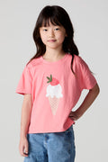 Front view of a girl wearing the Chaser Strawberry Ice Cream Tee on a neutral background