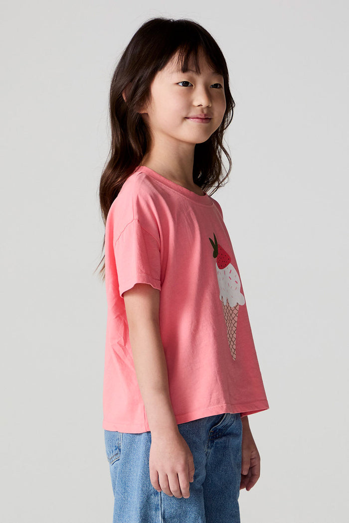 Side view of a girl wearing the Chaser Strawberry Ice Cream Tee on a neutral background