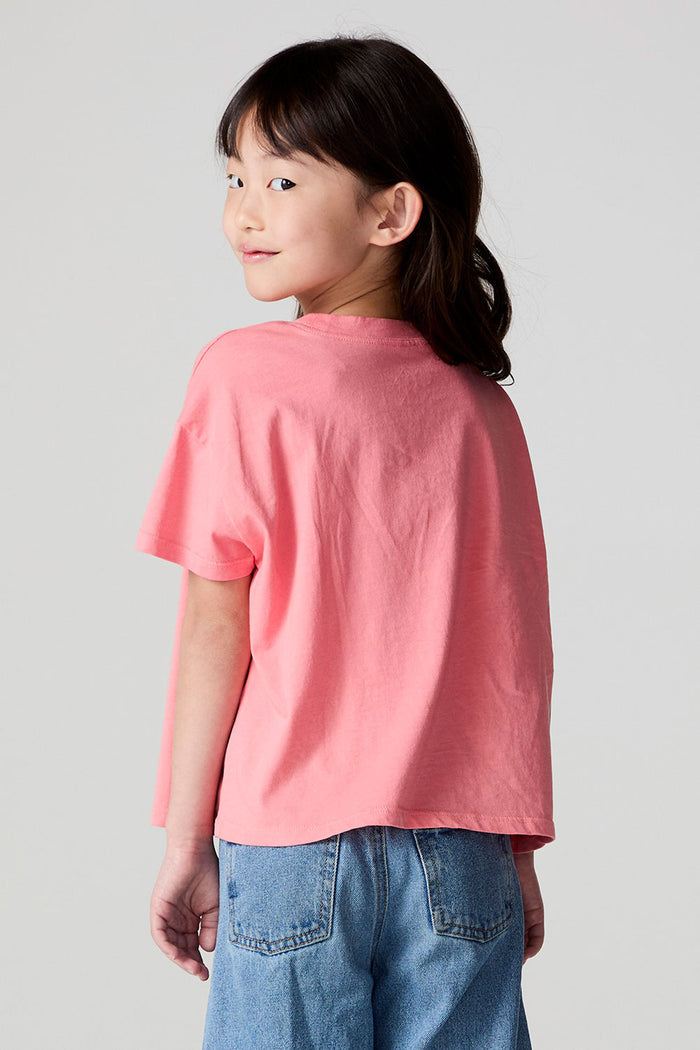 Back view of a girl wearing the Chaser Strawberry Ice Cream Tee on a neutral background