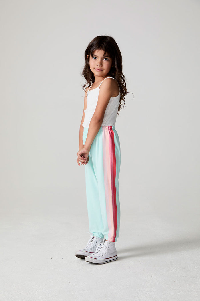 Full body side view of a girl wearing the Chaser   Stripes for Days Pants on a neutral background
