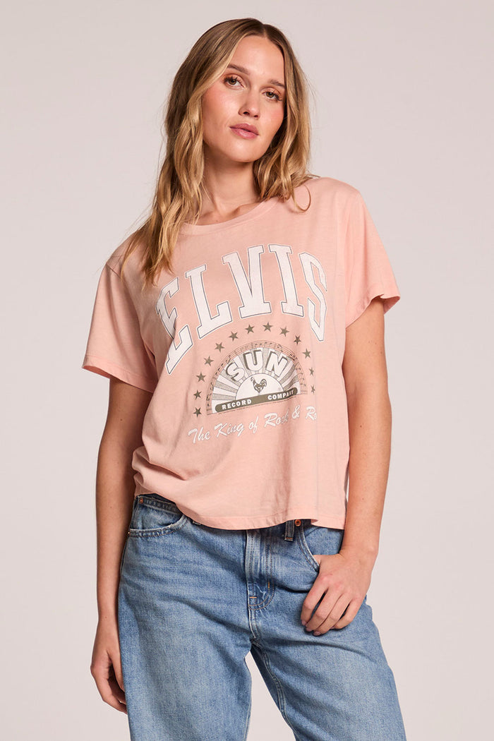 Front view of a woman wearing the Chaser  Sun Records Elvis Collegiate Tour Tee and jeans on a neutral background